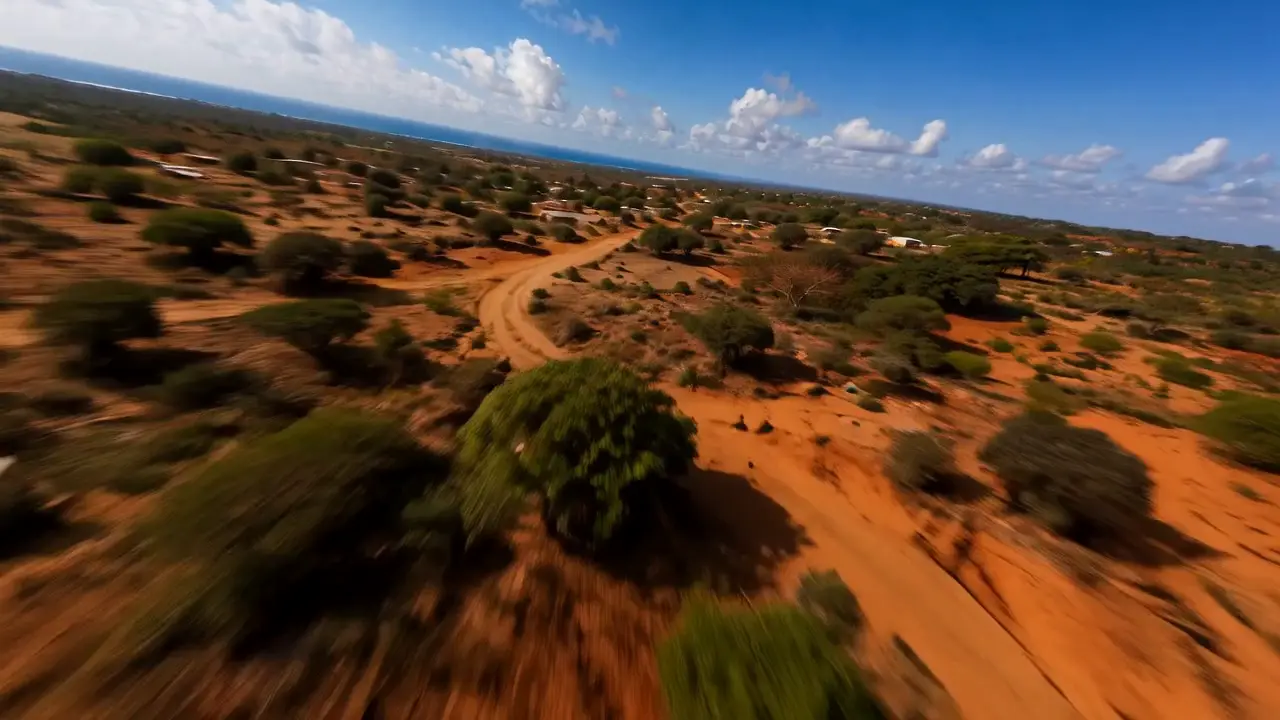 Natural river running through green land under open sky
